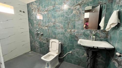 a bathroom with a toilet and a sink at Sunrise Prime in Kānke