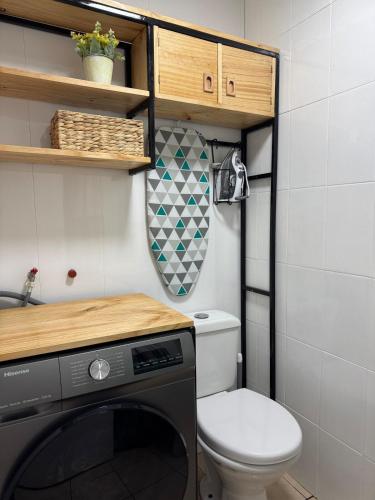 a small bathroom with a toilet and a sink at Casa 2 dormitorios - Punta Arenas - Río Seco in Punta Arenas