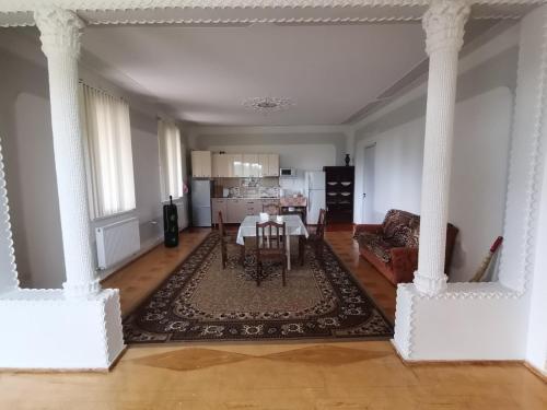 a living room with a table and a couch at Фазенда Оганеса in Ureki