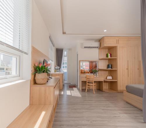 a kitchen and living room with a couch and a table at Nha Trang Center Point in Nha Trang