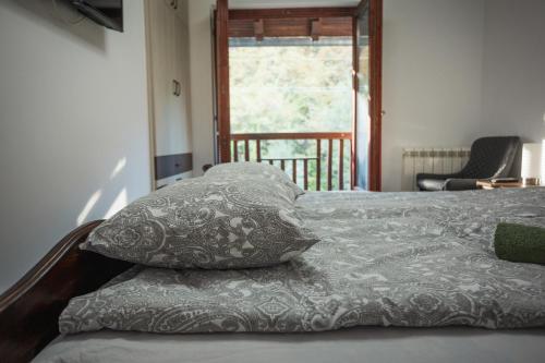 a bed with two pillows sitting on top of it at Vodenica kod Uče in Gukoš