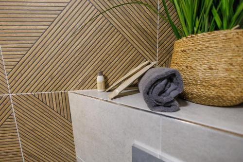 a bathroom with a towel and a plant on a counter at Boulevard Hotel in Aytos