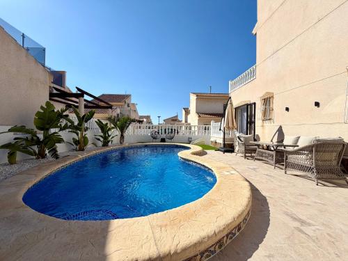 a swimming pool in the middle of a patio at Villa Emika with private pool in Ciudad Quesada in Ciudad Quesada