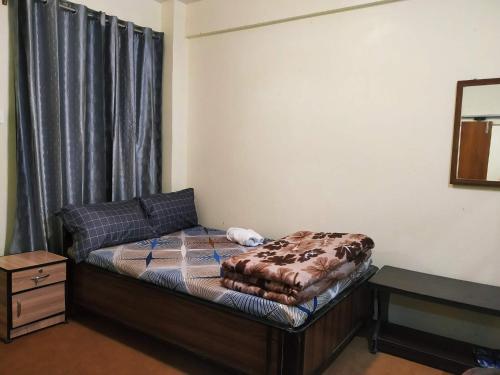 a small bedroom with a bed in a room at Lemon Tree Homestay Darjeeling in Darjeeling