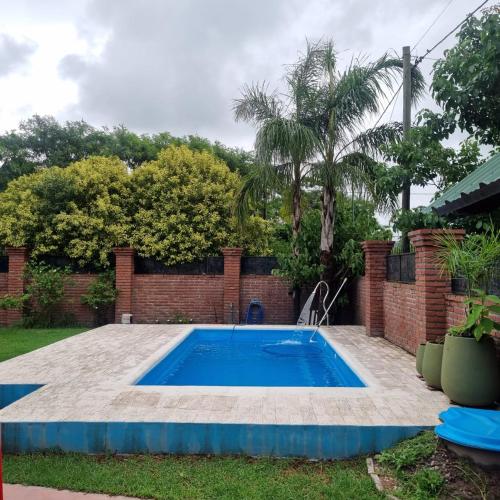 a swimming pool in the yard of a house at Cata, Casa de Descanso in Salta