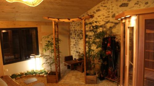 a living room with a table and some plants at Kokoro Lagoon in Saint-André-de-Sangonis