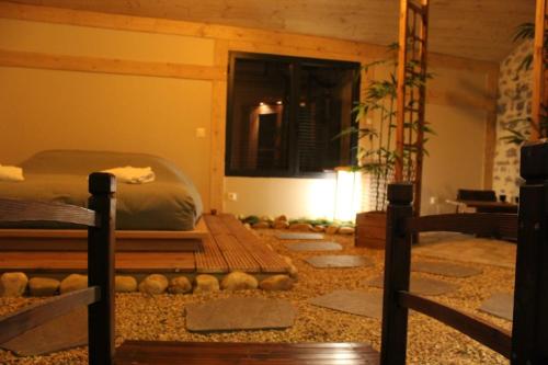 a room with a bed and some rocks on the floor at Kokoro Lagoon in Saint-André-de-Sangonis
