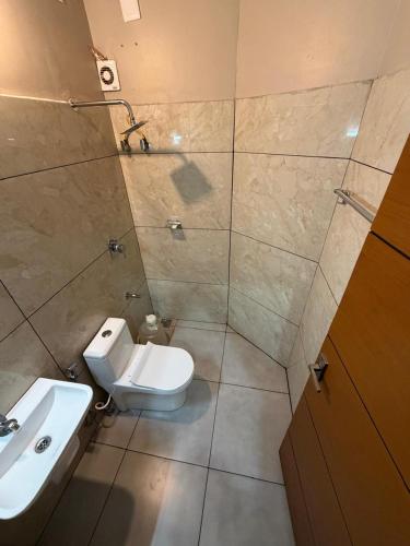 a bathroom with a toilet and a sink at Willow Nest in Anachal