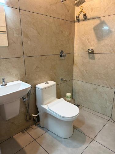 a bathroom with a toilet and a sink at Willow Nest in Anachal