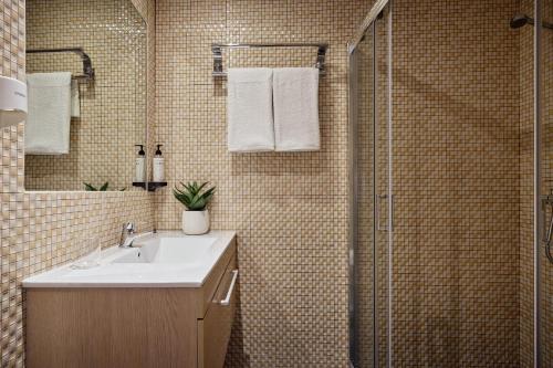 a bathroom with a sink and a shower at Paleokastritsa Palace - Adults Only in Paleokastritsa