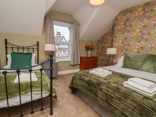 a bedroom with a bed and a window at Lansdowne Grange in Bridlington