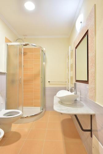 a bathroom with two sinks and a shower at Villa Fozzi in Bonorva