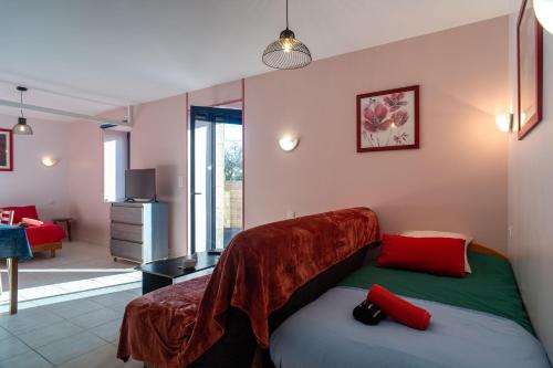 a bedroom with a bed with a blanket on it at Les Chouettes - Au Soleil Breton in Saint-Nic
