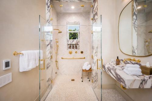 a bathroom with a shower and a glass shower stall at Polo House and Bungalows in Santa Ynez