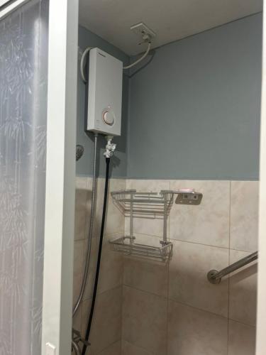 a shower in a bathroom with a shower at Davao Cozy Condo unit 1 in Davao City