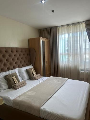 a bedroom with a large bed with two pillows on it at Davao Cozy Condo unit 1 in Davao City