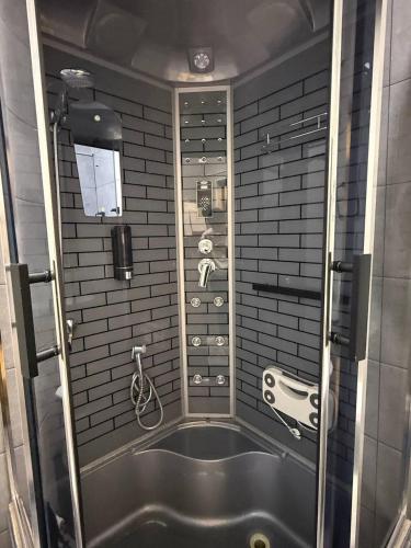 a bathroom with a bath tub with a shower at Royal Hotel Navoi in Navoi