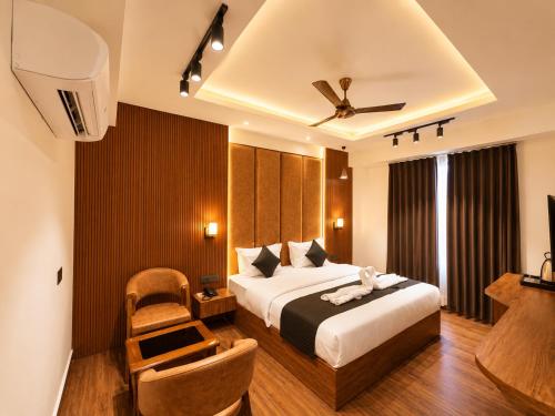 a hotel room with a bed and a chair at Casa Grande in Srinagar