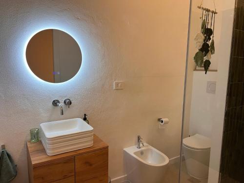 a bathroom with a sink and a mirror at Alessandra guest house in Alghero