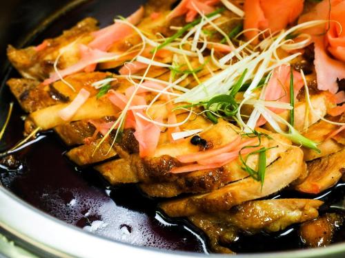 a bowl of food with meat and vegetables at 130 Hotel & Residence Bangkok in Bangkok