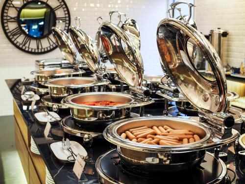 a bunch of pots and pans on a stove in a kitchen at 130 Hotel & Residence Bangkok in Bangkok