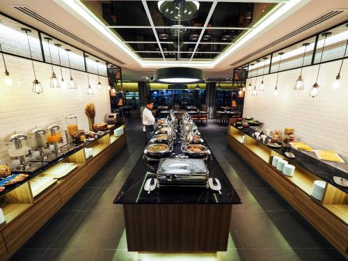 a buffet line in a restaurant with food on display at 130 Hotel & Residence Bangkok in Bangkok