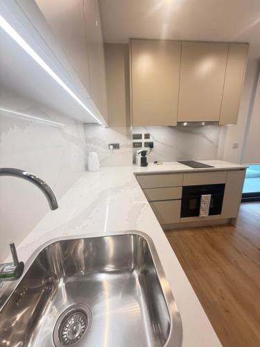 a kitchen with a sink and a counter top at Victory Suites in Gibraltar