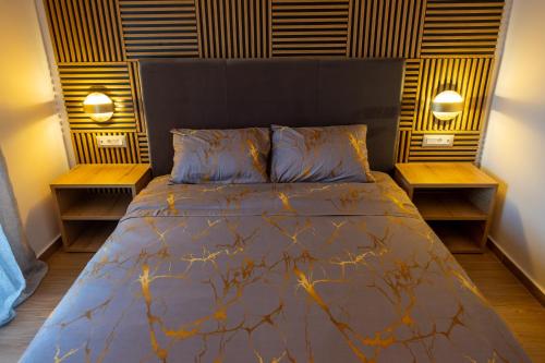 a bedroom with a large bed with two night stands at Maria - Christina House in Soroni