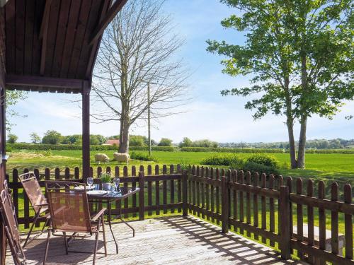 a patio with a table and chairs and a fence at Robin Lodge - E4478 in Nawton