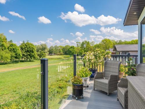 a porch with chairs and a view of a field at Sunnyfields in Cambridge