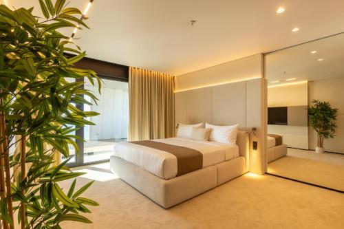 a hotel room with a bed and a mirror at OPUS Batumi in Batumi