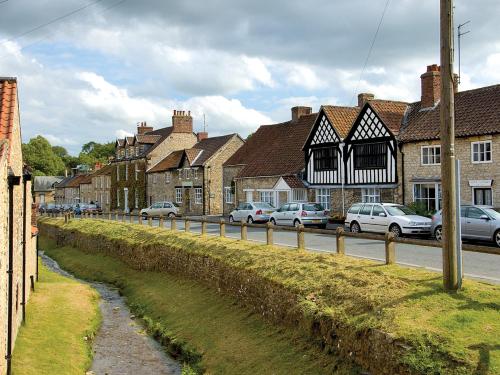 a town with cars parked on the side of a road at Wren Lodge - E5023 in Nawton