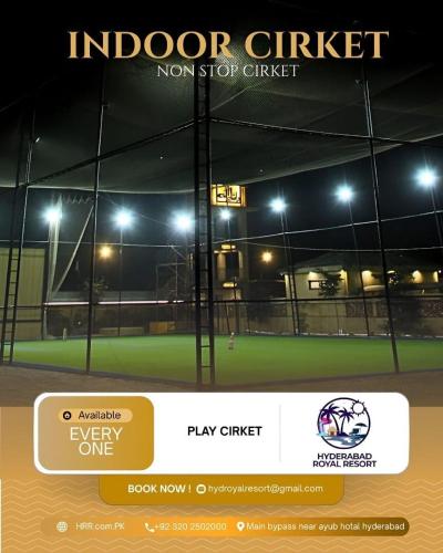 an advertisement for a tennis court at night at Hyderabad Royal Resort in Tālib Sumro