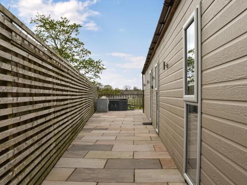 a walkway between a building and a fence at The Barbon - Uk47033 in Kirkby Lonsdale