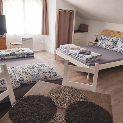 a living room with two beds and a table at Domeček in Třeboň