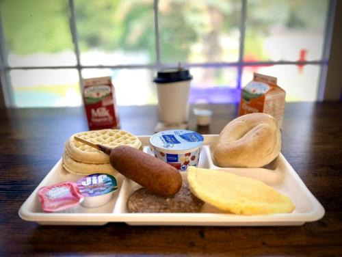 a tray of food with pretzels and donuts on a table at Claddagh Motel & Suites in Rockport