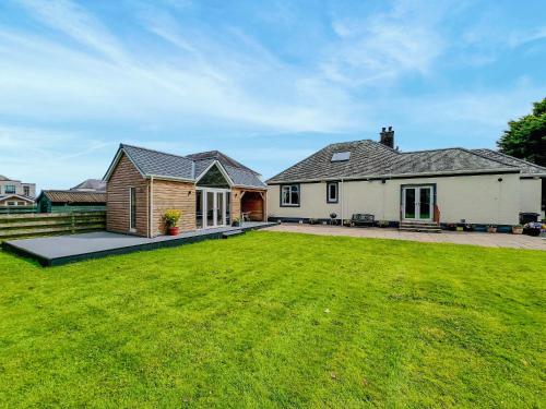 a house with a large lawn in front of it at Stronvaar in Stranraer