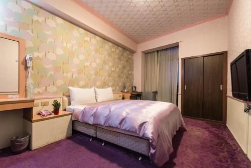 Citic Hotel tesisinde bir odada yatak veya yataklar