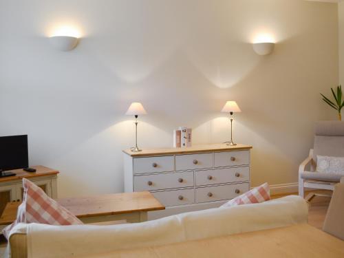 a living room with a dresser and a table at Percy's Place in Alnwick