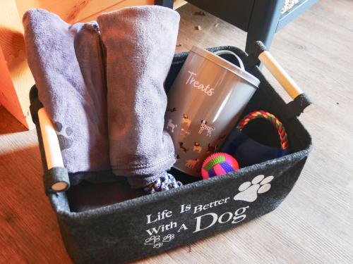 a bag with a book and boots and a baseball bat at Stable Lodge At Greenacre in Bromyard