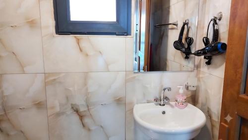 a bathroom with a sink and a mirror at Tsovazard Holiday House in Tsovazard