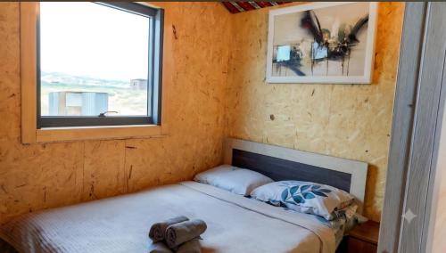 a small bed in a room with a window at Tsovazard Holiday House in Tsovazard