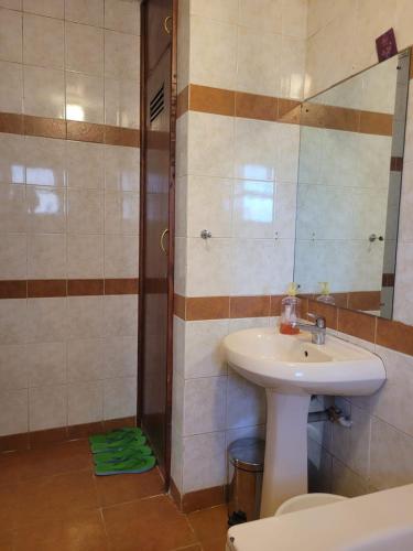 a bathroom with a sink and a shower at Lantana Luxe in Nairobi