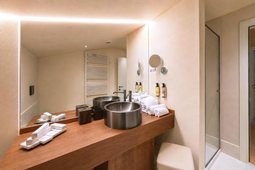 a bathroom with a counter with two pots and a sink at Resort Casa del Monte 1553 in Albenga