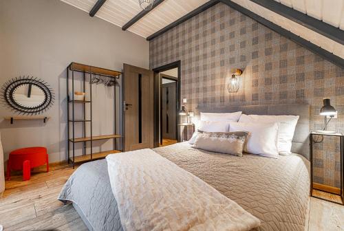 a bedroom with a large bed and a brick wall at Bieszczadzka Panorama in Ustrzyki Dolne