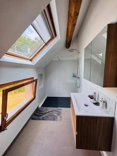a bathroom with a sink and a large window at La Masure in Les Rameaux