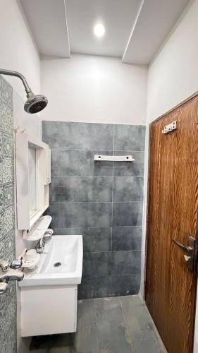 a bathroom with a sink and a shower at Complete Comfy House with 3 beds Al-Hafeez Garden Lahore in Lahore