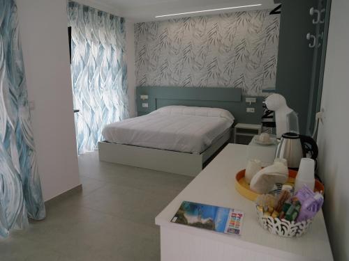 a small bedroom with a bed and a table with a book at Mgd House in Santa Domenica