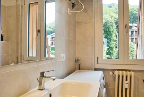 a bathroom with a sink and a mirror at Casa Rachele - mountain panorama in Cassina Valsassina
