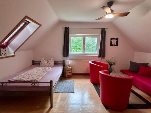 a room with a bed and a couch and a window at Ferien in Sachsen in Schmölln